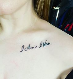 a woman with a tattoo on her chest that says i am not afraid to hear