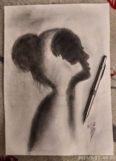 a pencil drawing of a woman's profile with her hand under her chin, and a pen resting on the paper