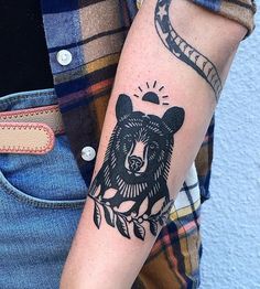 a person with a bear tattoo on their arm