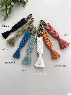 six different colors of rope keychais on top of a white sheet with words describing them