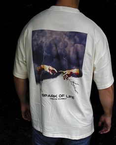 a man wearing a t - shirt with the words spark of life printed on it