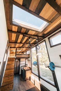 the inside of a tiny house with wood floors and skylights on the ceiling is shown