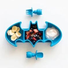 a batman shaped container filled with fruit and yogurt