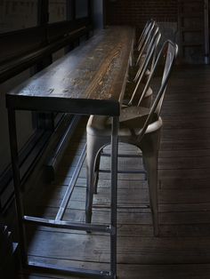 a long wooden table with metal chairs around it