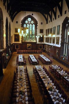 a large dining hall with tables and chairs set up for an event in the center