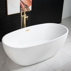 a large white bath tub sitting on top of a tiled floor next to a black wall