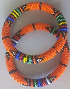 Beaded Bracelets | African Maasai Beaded Bracelets | African Jewelry | Zulu Beaded Bracelets | Ethnic Bracelets | Gift For Her | A Set Of Two These superbly crafted Zulu beaded bracelets are made of fine beads.The price is for a set of two bracelets.Main Color - Orange.Standard measurement is 7 - 8 inches.For smaller or bigger size please contact me.Available in different colors.Feel free to send me a convo or e-mail for any clarification.Thank you for visiting... Orange Bracelets As Festival Gifts, Orange Bracelet For Festivals As Gift, Orange Bracelets For Festivals Gift, Bohemian Orange Beaded Bangle Bracelets, Bohemian Orange Beaded Bangle Bracelet, Orange Festival Bracelet As Gift, Orange Bohemian Beaded Bangle Bracelet, Colorful Beads Bracelets For Festivals, Multicolor Round Beads Bangle For Festival