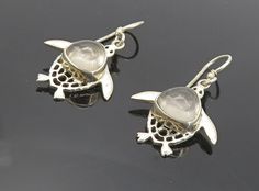 "925 Sterling Silver - Cabochon Cut Topaz Sea Turtle Dangle Earrings - EG3797  925 Sterling Silver - Cabochon Cut Topaz Sea Turtle Dangle Earrings - EG3797  Jewelry Type:         Earrings   Metal Type:            925 Silver   Metal Size:             1.25\"  Stone Type:            Topaz   Condition:              N/A  Jewelry Weight:     4.5 Grams  PLEASE NOTE: THIS ITEM IS PRE-OWNED. ALTHOUGH MOST ITEMS ARE IN VERY GOOD CONDITION, SOME MAY NEED CLEANING AND/OR MINOR REPAIRS. WE MAKE A VERY STRONG EFFORT TO UPLOAD CLEAR PICTURES. PLEASE INSPECT ALL PICTURES AND ASK ALL QUESTIONS YOU MAY HAVE PRIOR TO MAKING A PURCHASE. NOT ALL STONES ARE GENUINE, SOME ARE ENHANCED OR CREATED." Silver Cabochon Teardrop Earrings, Silver Teardrop Cabochon Earrings, Silver Cabochon Dangle Earrings, Silver Cabochon Drop Earrings, Earrings Metal, Sea Turtle, Types Of Metal, Metallic Silver, Topaz