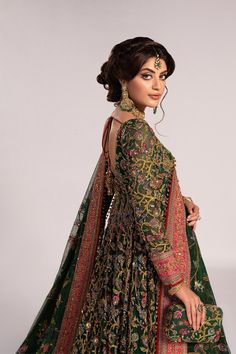 Green Pakistani Mehndi Dress in Pishwas Frock Style is paired with Lehenga, creating a lavish Pakistani Bridal Dress. Lavish floral designs and hand-crafted details of ornaments make this stunning Mehndi Dress a perfectly glamorous choice to wear on the most important day of your life. Pakistani Bridal Pishwas: Pakistani Bridal Pishwas in an an alluring green color has premium organza fabric. The Pishwas Frock is gracefully emblazoned with zardosi, dabka, gota, sequins, naqshi, and motifs. Embroidery, floral designs, and crystals give a perfect finishing look to the Pishwas. Bridal Lehenga: The Bridal Lehenga has premium quality silk fabric and it looks perfect with the heavily embellished Pishwas Frock. The Lehenga has a huge flare and its borders in alluring pink color are emblazoned wit Designer Green Choli With Dabka Detailing, Eid Anarkali Jamawar Gown, Traditional Jamawar Gown With Resham Embroidery, Floor-length Jamawar Dress For Reception, Anarkali Gown With Zari Work In Jamawar, Unstitched Anarkali Jamawar Gown, Anarkali Jamawar Gown With Dupatta, Unstitched Jamawar Anarkali Gown, Jamawar Dress With Traditional Drape For Reception