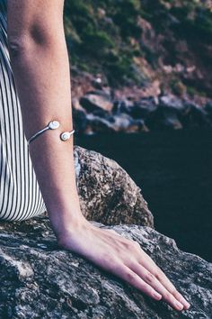 Our 925 Sterling silver delicate bracelet is perfect for elegant ocasions. This unique design consists in two stones of Santa Lucia 14 mm in oval shape, a natural shell also know as Shiva Eye Shell. The shiva shell is a natural fossil seashell. This piece is fully adjustable, able to wear it on the up side of the arm or on the wirst. This delicate bracelet is the a perfect present for all those who loves the sea and natural beauty. Details: - 925 Sterling Silver Stamp - Able for sensitive skins. Adjustable Silver Pearl Bracelet For Friendship, Minimalist White Gold Oyster Bracelet, Adjustable Sterling Silver Pearl Bracelet Nickel Free, Adjustable Sterling Silver Bangle With Bracelet Strap, Adjustable Nickel-free Sterling Silver Pearl Bracelet, Adjustable Minimalist Sterling Silver Bracelet, Sterling Silver Jubilee Bracelet For Friendship, Minimalist White Sterling Silver Bangle Bracelet, Minimalist White Sterling Silver Bangle