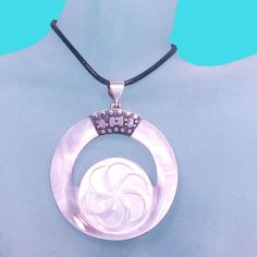 ** Beautifully Handcrafted by highly skilled artisans in Bali, Indonesia  ** Natural White Mother of Pearl is smooth, and shimmers a luminous glow ** Sterling Silver Bail and Unique Applique ** Round Shape Mother of Pearl Pendant with 925 Sterling Silver Applique ** Carved Flower  ** Natural Shell on back ** Measures 2 inches Long & 2 inches Wide ** 18" Black Cord Included ** Nicely Presented in a Gift Box ** All our items are hand selected by us, insuring high quality and great value  ** We hav Silver Mother Of Pearl Round Shell Necklace, Silver Round Mother Of Pearl Shell Necklace, Silver Round Shell Necklace For Gifts, Silver Mother Of Pearl Shell Necklace, Handmade Silver Shell Necklace As Gift, Silver Applique, Mother Of Pearl Pendant, Pearl Shell, Handmade Pendant