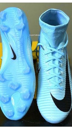 a pair of blue and black nike soccer cleats