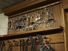 a wooden shelf filled with lots of different types of scissors