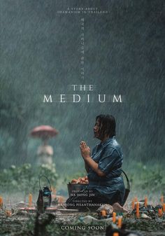 the medium movie poster with a woman praying in the rain