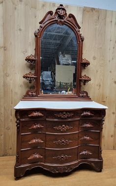 an old dresser with a mirror on top