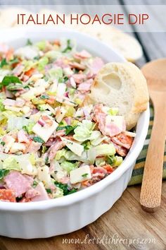 a white bowl filled with salad next to bread