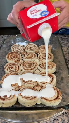 cinnamon rolls being poured onto a baking sheet