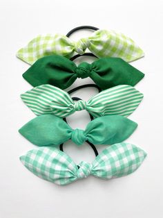 Green Hair Bow. 6.5 inches wide Attached to your choice of a thick or thin hair elastic or a 2.4 inch alligator clip Made of a cotton blend fabric, sewn on all sides and handmade with care by yours truly.  {NOTE} Every hair scarf is lovingly handmade and hand-tied, therefore please allow for slight variations due to fabrics and patterns.  {ABOUT OUR HAIR ELASTICS} Our hair elastics are metal free and of the highest quality. This bow is NOT glued in place on the bow so that you can easily style y Green Hair Accessories, Hair Accessories Green, Sports Hair, Hair Elastic, Green Bows, Hair Scarf, Hair Elastics, Green Hair, Scarf Hairstyles