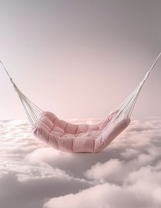 a pink hammock hanging above the clouds