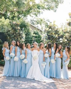 a group of bridesmaids in blue dresses