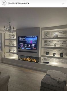 a large flat screen tv mounted to the side of a wall in a living room