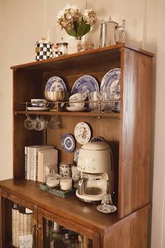 a wooden shelf with plates and cups on it