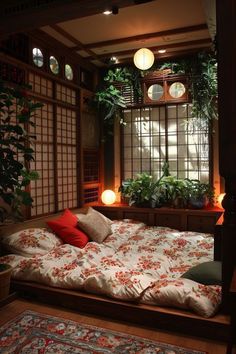 a bed sitting under a window next to a plant filled wall with potted plants