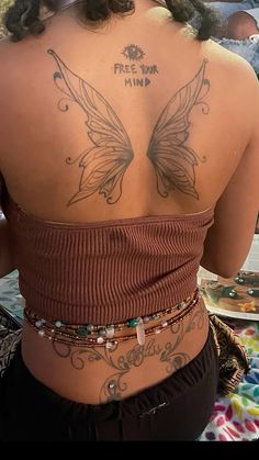 the back of a woman with tattoos on her body