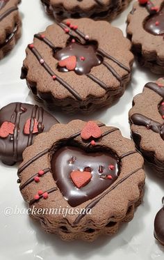 heart shaped cookies with chocolate frosting and hearts on them are arranged in a circle