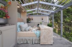 an outdoor patio with furniture and flowers on the table