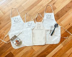 three aprons with the words chef's kitchen written on them and eggs laid out next to each other