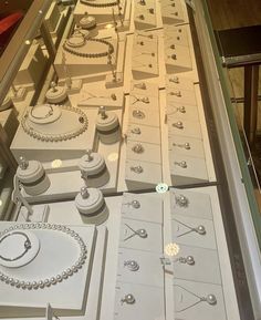 a display case filled with lots of white jewelry