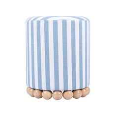 a blue and white striped ottoman with wooden beads