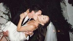 a bride and groom kissing on their wedding day