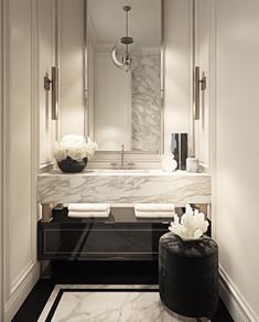 an elegant bathroom with marble counter tops and white walls, along with black flooring