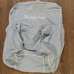 a bed with the name madeline on it sitting on top of a wooden floor