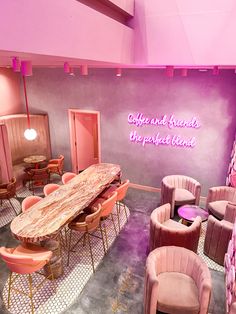 a room with pink chairs, tables and a sign that says coffee and friends are perfect blend