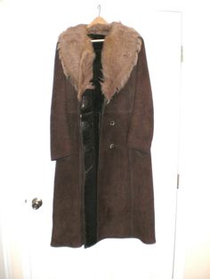 For your consideration the WOMEN'S BROWN GENUINE SHEEPSKIN FULL  LENGTH COAT.  I am assuming this coat was made in Italy. This coat is pre-owned. Warn only for one season. Moved to S. California and never warned again. Bought this coat in Rome, Italy in the store specialized selling only such coats.  Very good condition. Has two front pockets. This coat will keep you warm and safe in the severest cold weather conditions. If you get cold in this .....  stay inside.   There are some dimensions on Formal Long Brown Outerwear, Brown Winter Fur Coat For Formal Occasions, Brown Long Fur Coat For Winter, Brown Fur Coat For Formal Winter Occasions, Brown Long Fur Coat For Fall, Brown Full-length Outerwear For Fall, Formal Brown Fur Coat For Fall, Brown Leather Long Fur Coat, Classic Brown Long Fur Coat