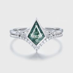 a white gold ring with a green tourmaline and diamonds