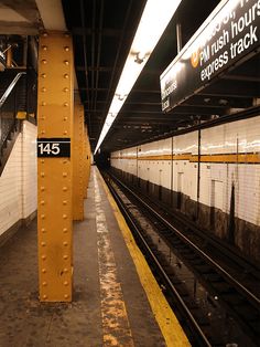 an empty subway station with no people on the platform