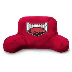 a red pillow with the logo of razorbacks on it, sitting in front of a white background