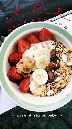 a bowl filled with fruit and granola on top of a table