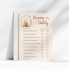 a baby shower checklist with a teddy bear sitting on it's back side