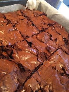 a pan filled with brownies covered in chocolate