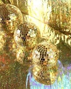 three shiny disco balls sitting on top of a table