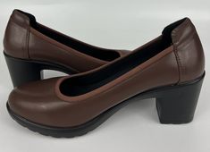 Elevate your style with these gorgeous Dream Pairs Edena pumps. The brown PU leather upper material with layered accents and a closed toe shape add a touch of elegance to any outfit. The slip-on closure and block heel style provide comfort and versatility for any occasion, whether it's a wedding, party, or business meeting. The synthetic outsole material and foam insole material make these pumps perfect for any season, and the 2.8-inch heel height with a 2.8-inch platform height will give you the perfect amount of lift. These pumps are a size 8.5 in US shoe size, and 6.5 in AU shoe size, with a standard shoe width. These beautiful heels are perfect for any fashion-forward woman who wants to make a statement with their shoes. Brown Block Heel Heels For Work, Brown Block Heel Shoes For Work, Brown Block Heel Workwear Heels, Brown High Heel Court Shoes With Stacked Heel, Brown Stacked Heel Heels For Work, Brown Medium Width Heels For Work, Brown Block Heel Court Shoes With Reinforced Heel, Brown Stacked Heel Court Shoes For Fall, Brown Court Shoes With Stacked Heel For Fall