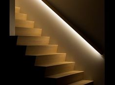 the stairs are lit up and there is only one light in the room to illuminate them