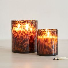 two candles sitting next to each other on a table