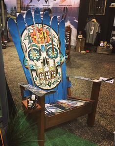 a wooden chair with a painted sugar skull on it and skis attached to the back