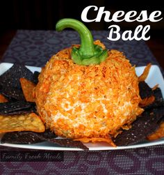 a white plate topped with cheese ball and tortilla chips